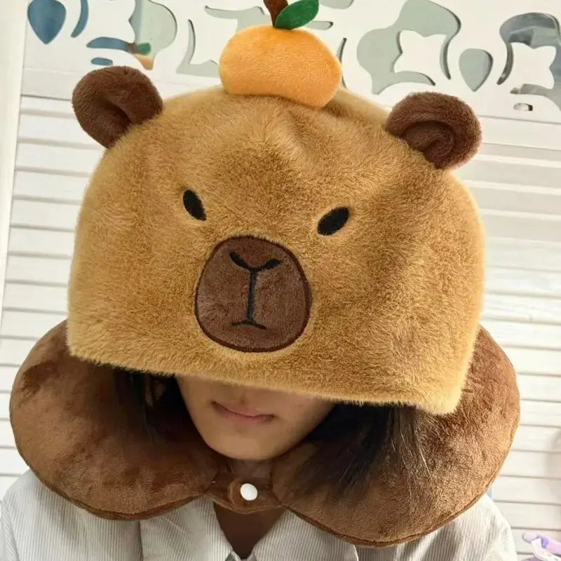 Travel pillow with capybara hood