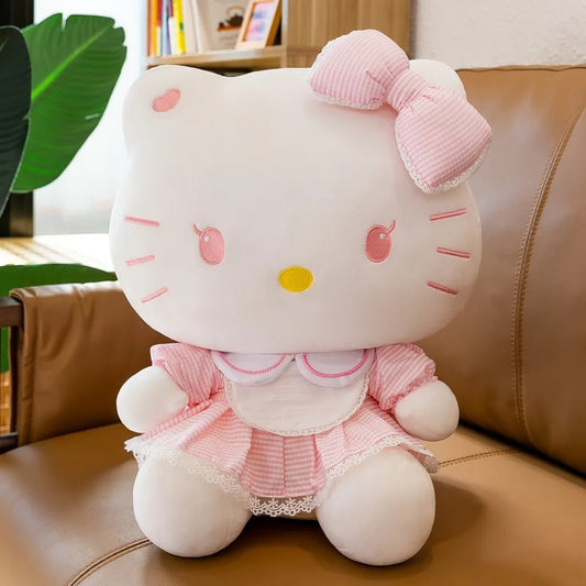 peluche Hello Kitty rose de face sur canapé
